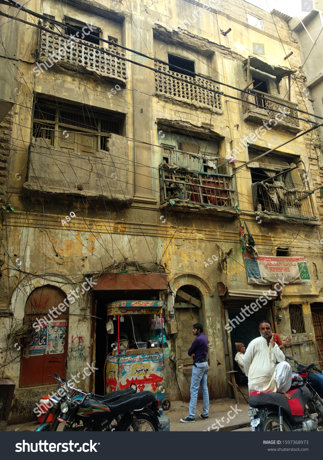 stock-photo-an-old-abandoned-building-in-kharadar-area-people-are-standing-in-front-of-the-building-karachi-1597368973